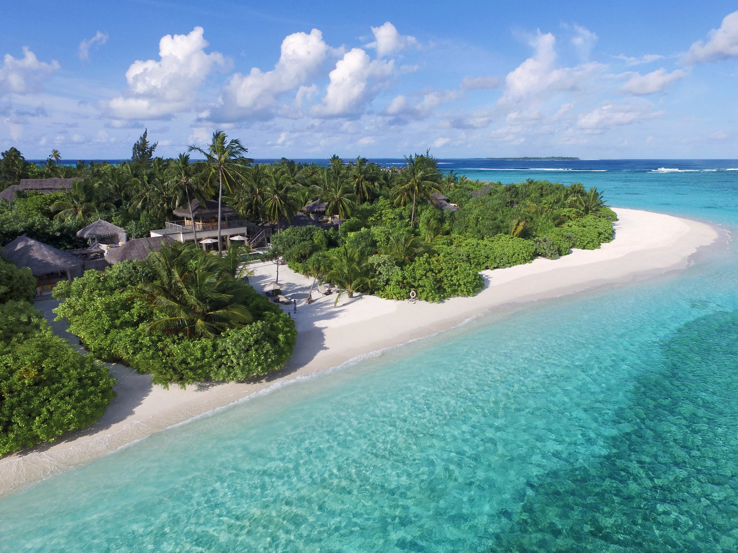 Aerial view of a beach villa with pool and the island coast, Six Senses Laamu
