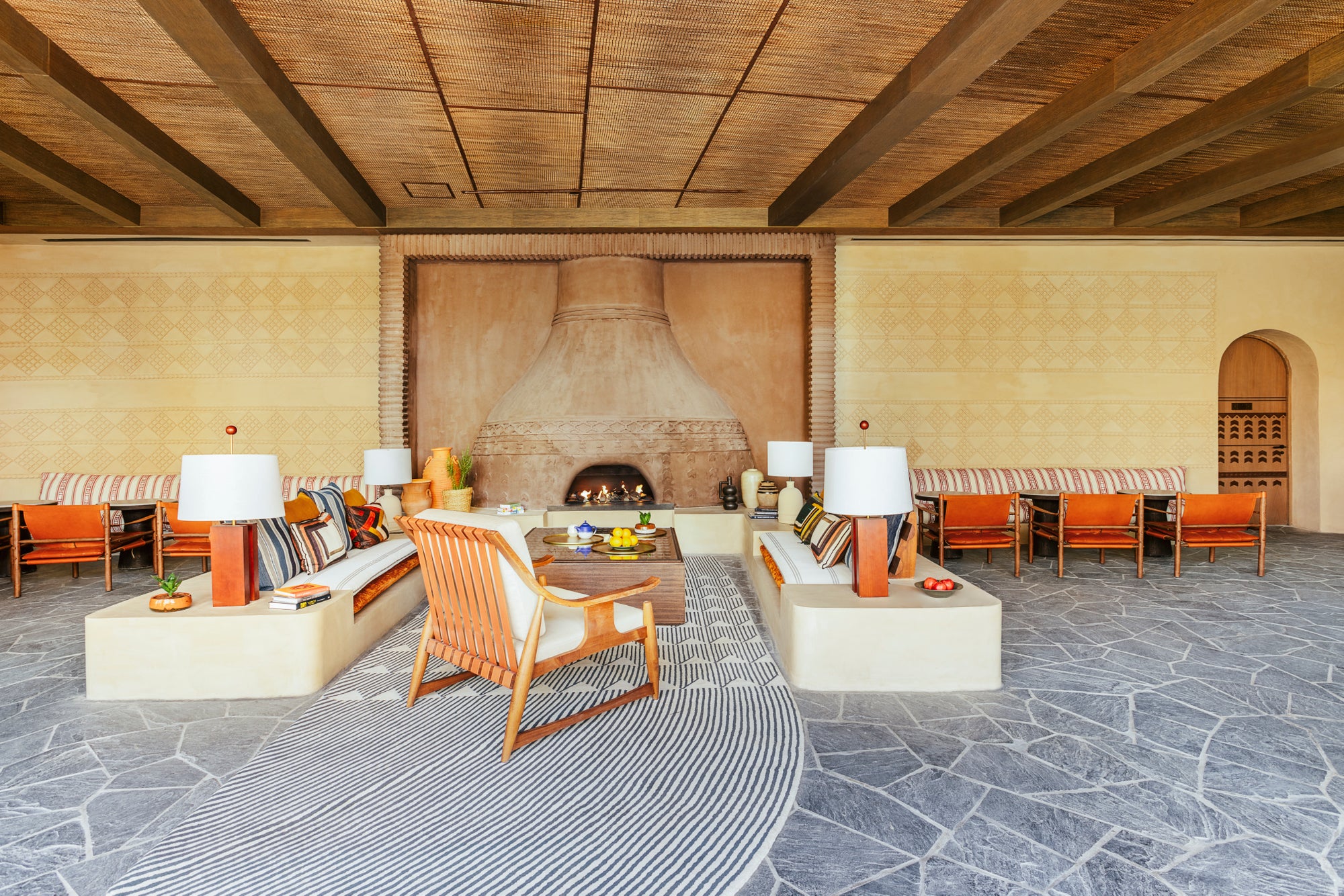 The Community Lounge, with its central adobe fireplace, Six Senses Southern Dunes