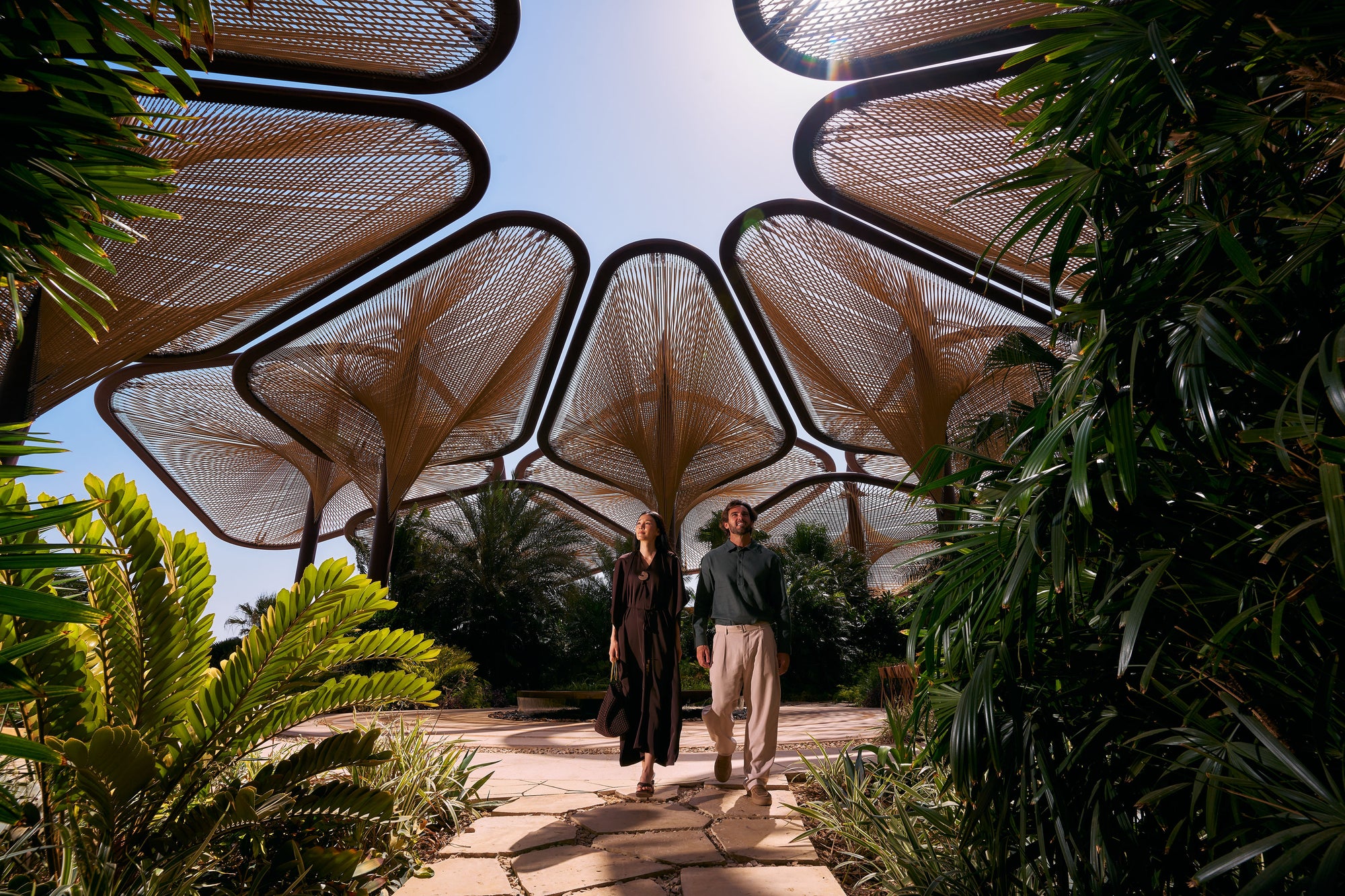 Two guests walking beneath the canopy, Six Senses Southern Dunes