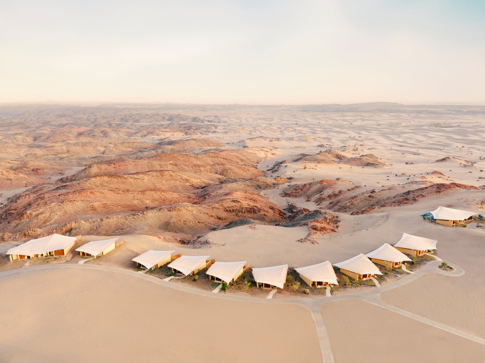 The villa roofs follow a curve along the plateau, Six Senses Southern Dunes