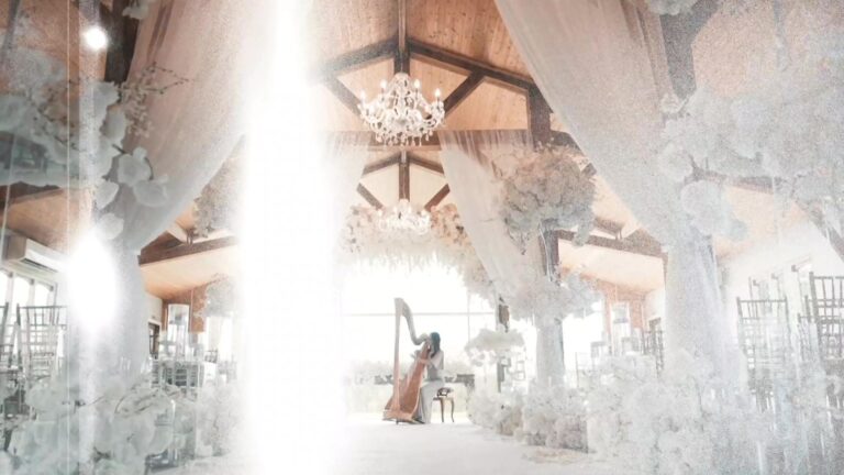 A harpist performs in a spectacular chandelier-lit ceremony space, Six15 Events