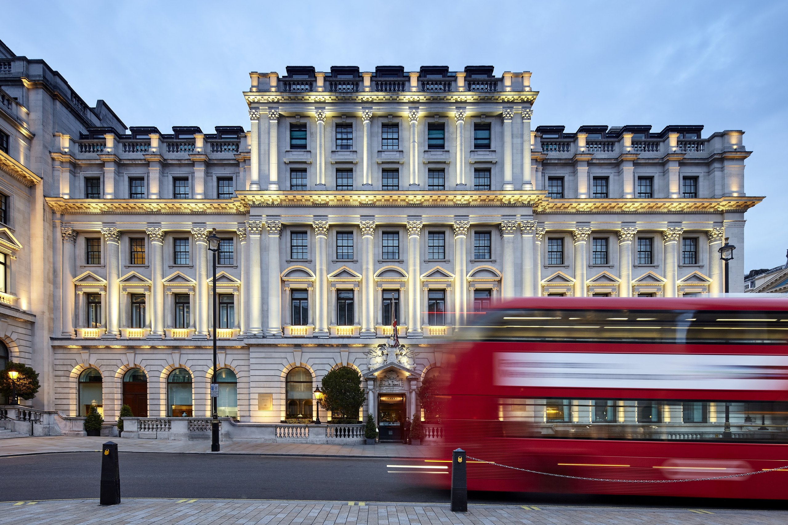 The Waterloo Place facade with a red London bus passing in front, Sofitel London St James