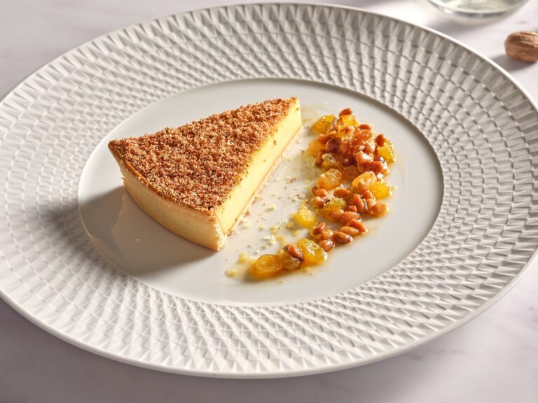 A slice of custard tart with roasted nuts and raisins at Wild Honey St James, Sofitel London St James