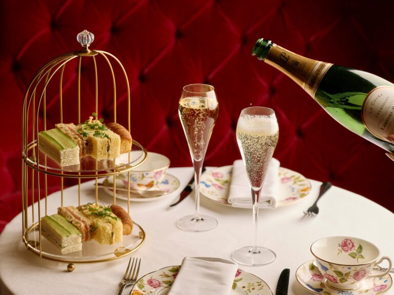 Afternoon tea sandwiches on a gilt stand with Champagne in the Rose Lounge, Sofitel London St James