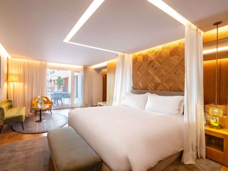 Suite bedroom with canopy drapes, Sofitel Marrakech Lounge and Spa