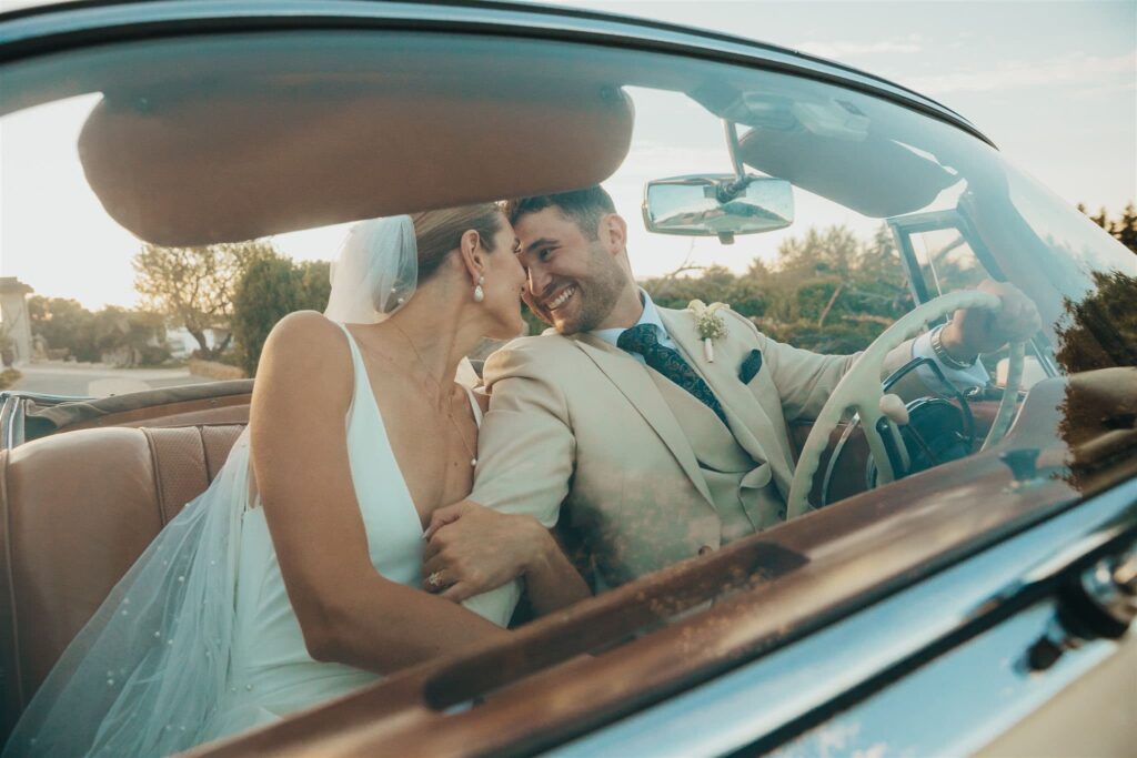 A couple laughing together in a vintage convertible, Solar do Paço Algarve