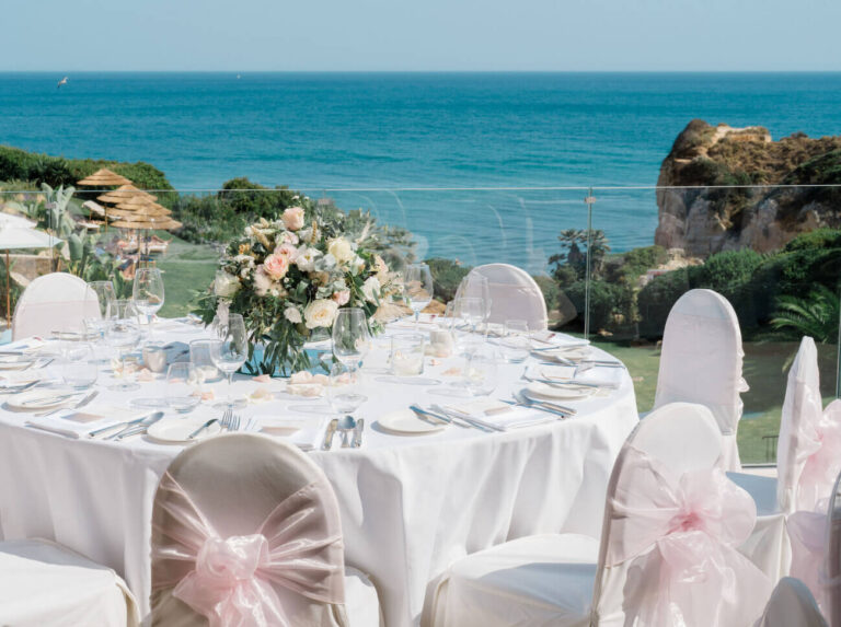 Round banquet table with pink and ivory styling overlooking the Algarve coast, Sonho a Dois Algarve Wedding Planners