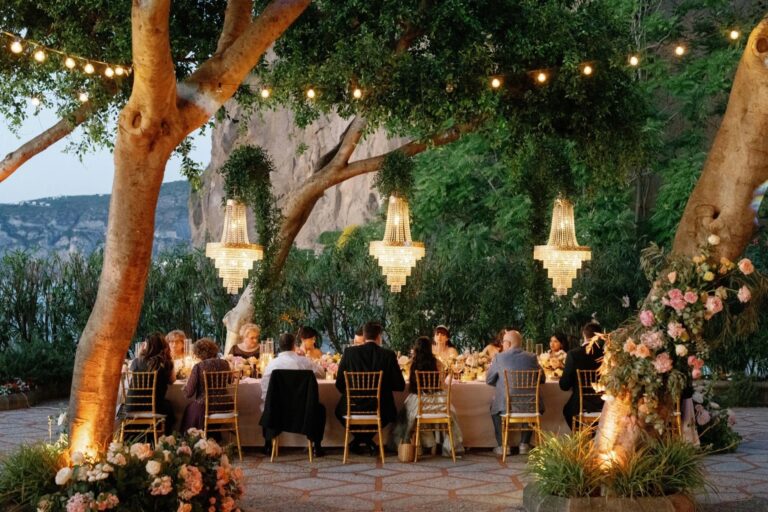 Dinner under chandeliers and festoon lights in the garden of the Grand Hotel Royal, Sorrento, Sophisticated Weddings