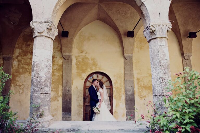 Couple in a cloister archway on the Amalfi Coast, Sophisticated Weddings