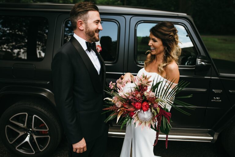 The bride and groom, late at night, a coral protea bouquet, Sorcha Herbert Flowers