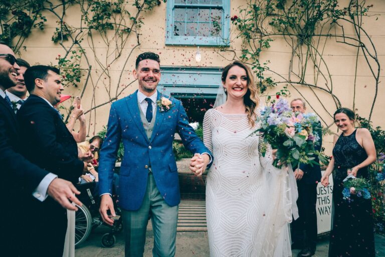 The bride and groom embrace, a candlelit courtyard, Sorcha Herbert Flowers