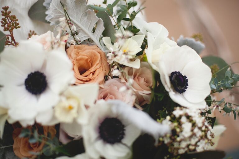 A bouquet of white anemone, orange ranunculus and eucalyptus, Sorcha Herbert Flowers