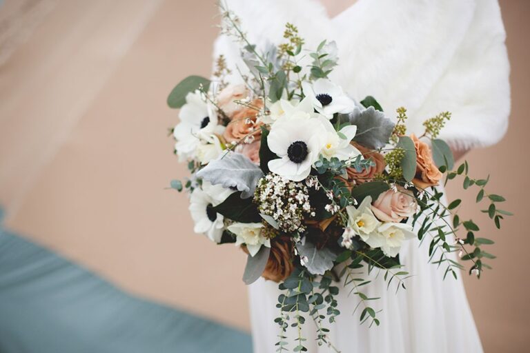A bouquet of anemone and astrantia against powder blue, Sorcha Herbert Flowers