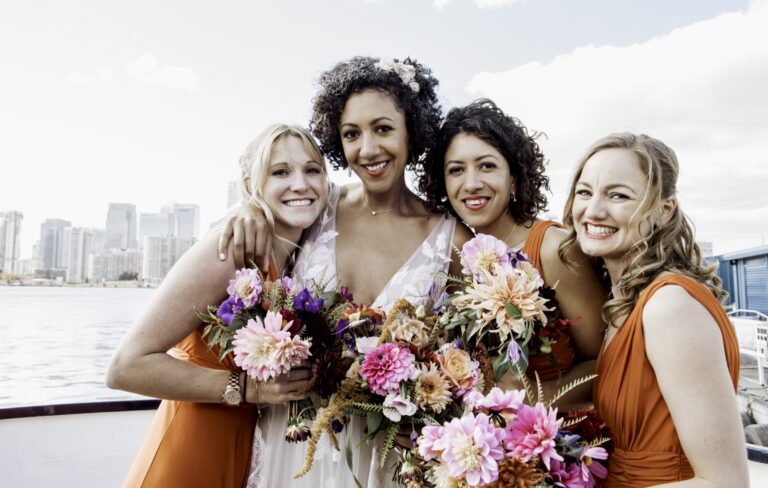 Bridesmaids in burnt orange, the skyline beyond, Sorcha Herbert Flowers