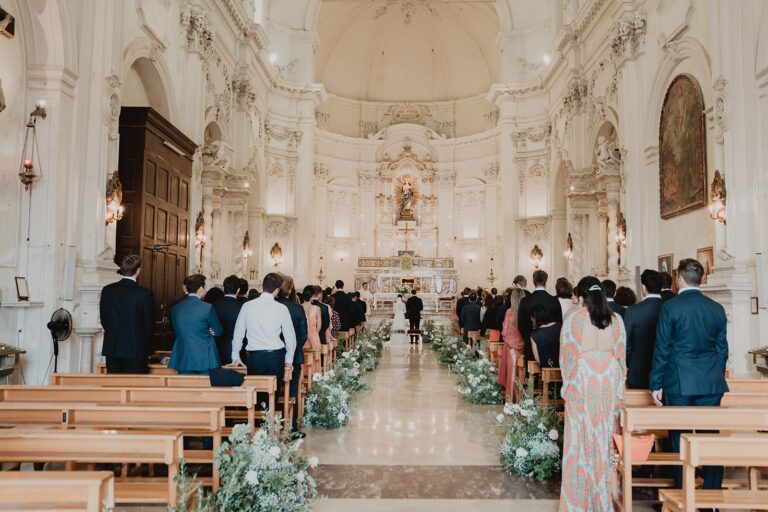 The ceremony aisle inside a Noto church, guests standing beneath a gilded Baroque dome, Sparx Wedding & Event Planner
