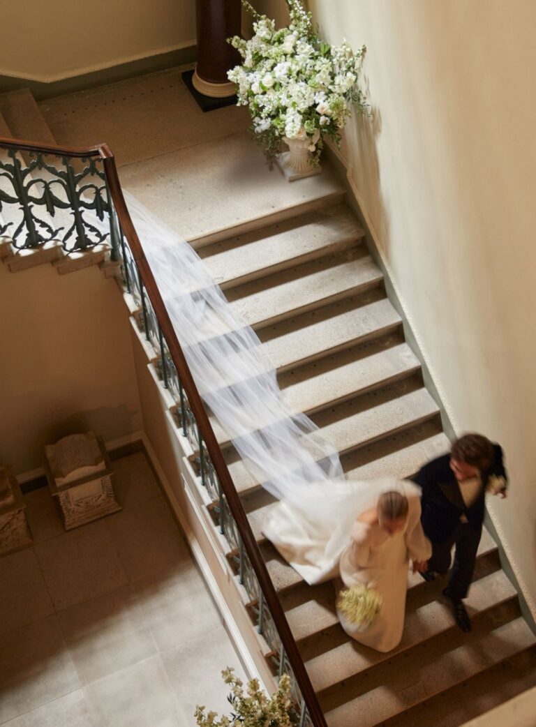 A bride and groom on the staircase at Spencer House, Spencer House