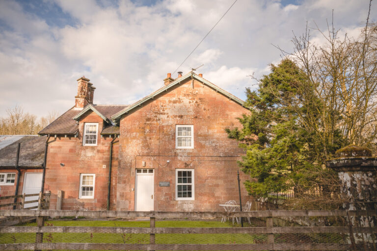 Chauffeur's Cottage, a two-storey sandstone cottage by the old stable yard, Springkell