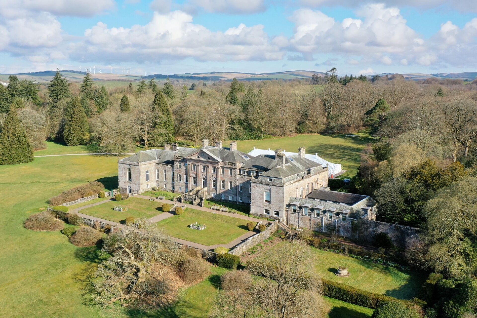 Springkell from the air, with the walled terrace gardens in front of the house and woodland all around, Springkell
