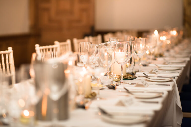 A long table laid with candles, glassware and Chiavari chairs, Springkell
