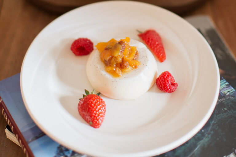 A panna cotta dessert with fruit compote and fresh berries, Springkell