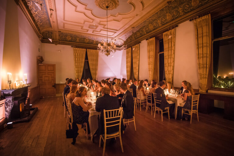 A candlelit dinner party under the ornate ceiling of the Ceremony Room, Springkell