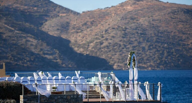 Chairs set out on the deck above the water for a ceremony, St Nicolas Bay Resort Hotel and Villas