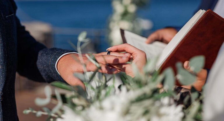 A couple exchanging rings at a ceremony, St Nicolas Bay Resort Hotel and Villas
