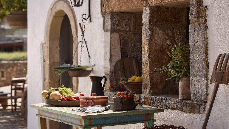 A stone arched courtyard with fresh produce, St Nicolas Bay Resort Hotel and Villas