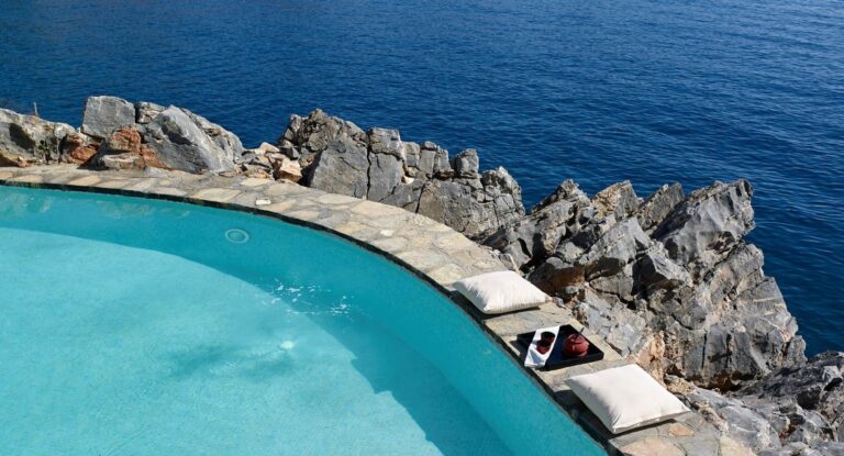 A pool beside the rocks above the sea, St Nicolas Bay Resort Hotel and Villas