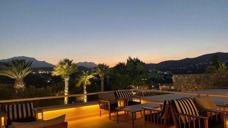 A terrace at dusk with the hills behind, St Nicolas Bay Resort Hotel and Villas