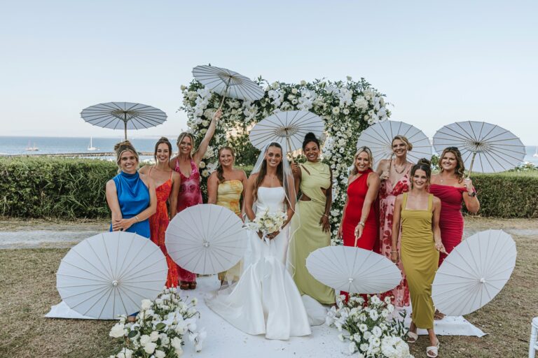 Payton with her bridesmaids, white parasols and floral arch at the Torre di Michelangelo, Ischia, Stefania Silvestro