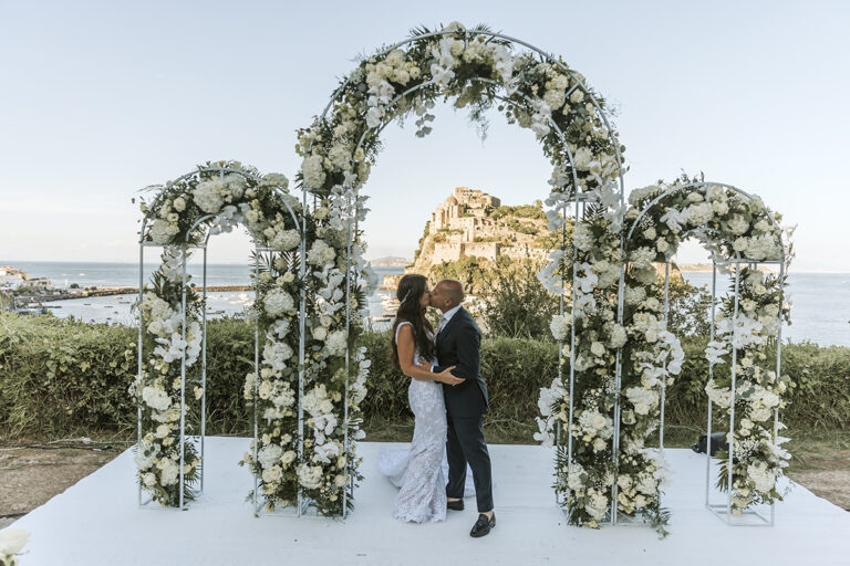 Floral arches for Samantha and Alphonse's civil ceremony at the Torre di Michelangelo, Castello Aragonese beyond, Ischia, Stefania Silvestro