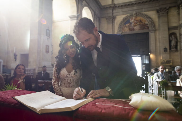Signing the register at a church wedding, light flaring across the altar, Stefano Lunardi