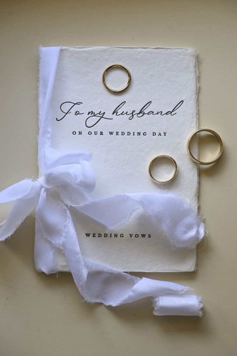 Wedding vows booklet, ribbon and gold rings laid out before the ceremony, Stefano Lunardi
