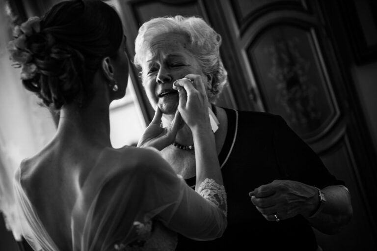The bride's mother wiping away a tear while she gets ready, in black and white, Stefano Lunardi