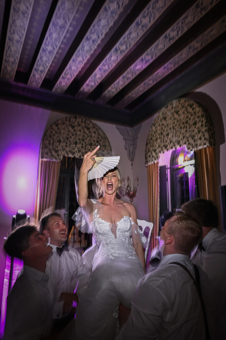 The bride lifted shoulder-high by her friends at the party, Stefano Lunardi