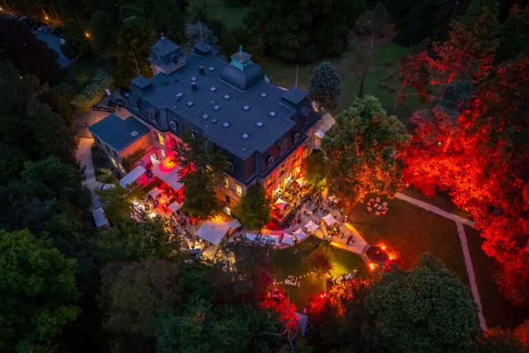 Villa and park lit at night from the air, Stella Rheni
