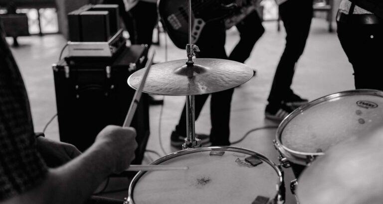 A black and white close view of drums and cymbals mid-performance, Stereo Star Band