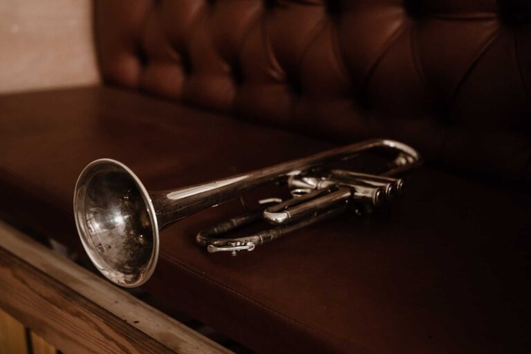 A trumpet resting on a dark leather surface, Stereo Star Band