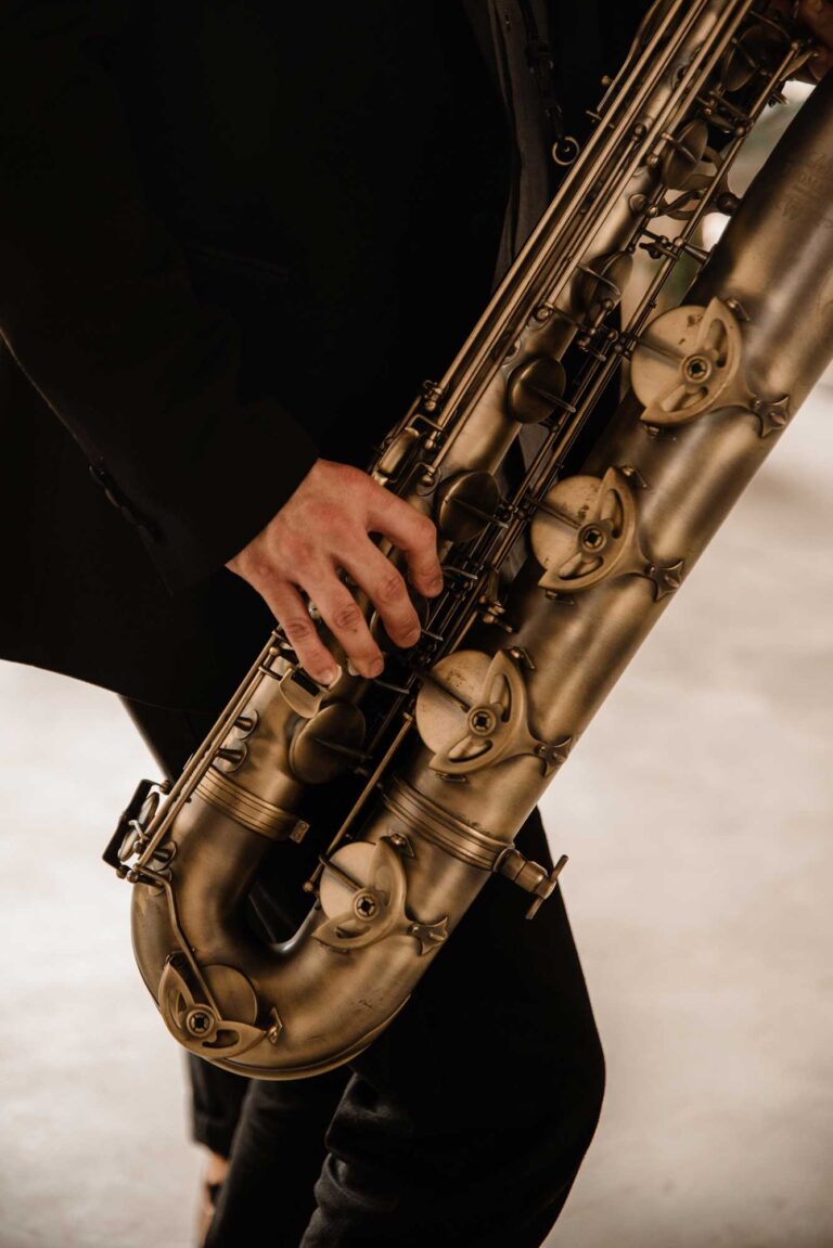 Hands on the keys of a brass baritone saxophone, Stereo Star Band