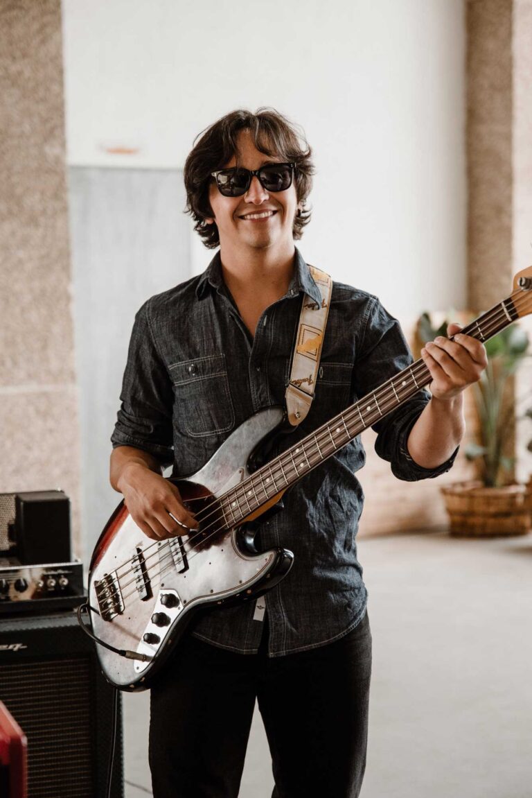 A bass player smiling in sunglasses, Stereo Star Band