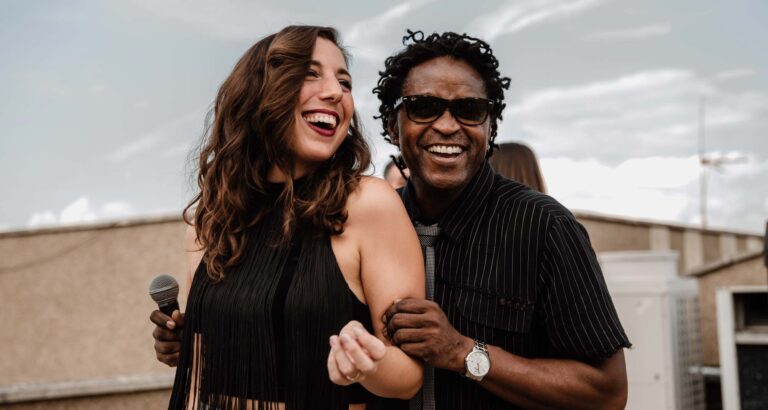A female singer and a male singer laughing together on stage, Stereo Star Band
