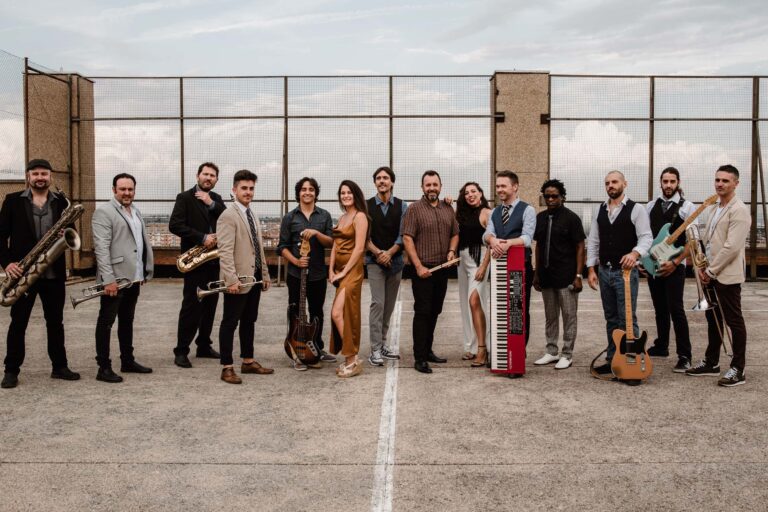 The band standing together on a rooftop terrace under a pale sky, Stereo Star Band