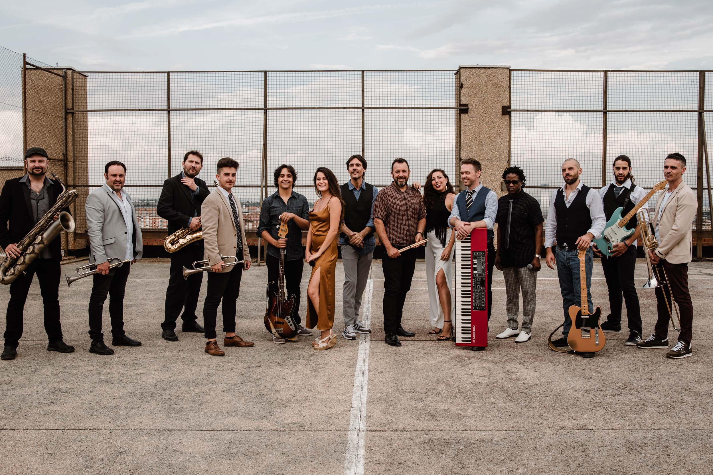 The band standing together on a rooftop terrace under a pale sky, Stereo Star Band