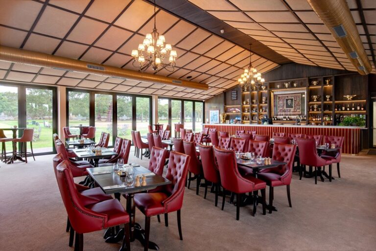 Dining room with red leather chairs and garden views, Stoke Park