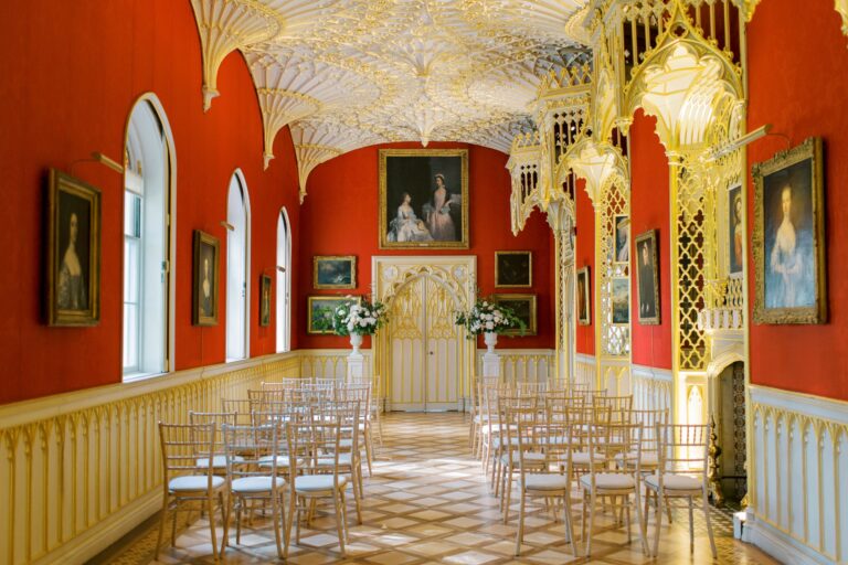 The Gallery set for a civil ceremony, chairs in rows beneath the gilded fan-vaulted ceiling and crimson walls, Strawberry Hill House