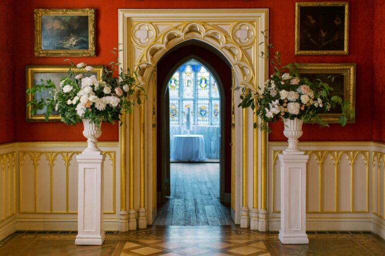 A Gothic arched doorway dressed with floral urns, framing the way through to the reception, Strawberry Hill House