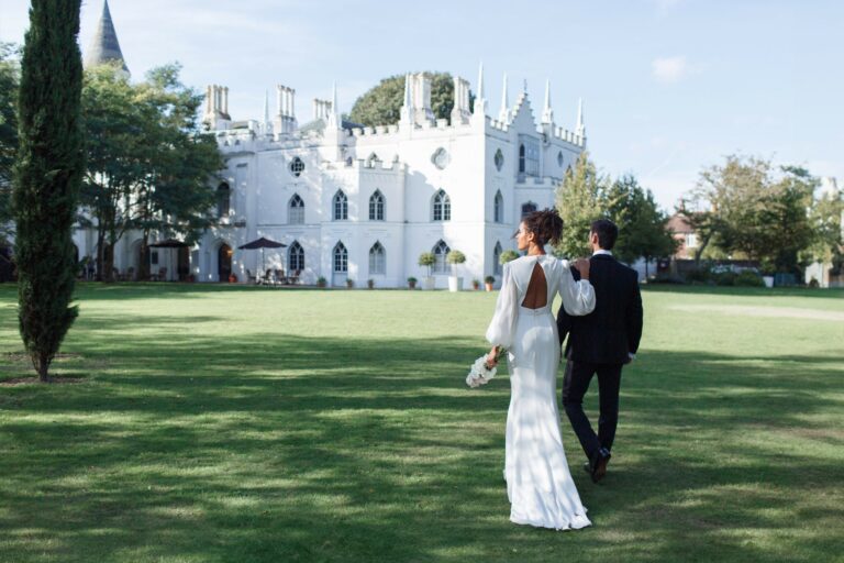 A newly married couple walking across the lawn toward the white Gothic front of Strawberry Hill House, Strawberry Hill House
