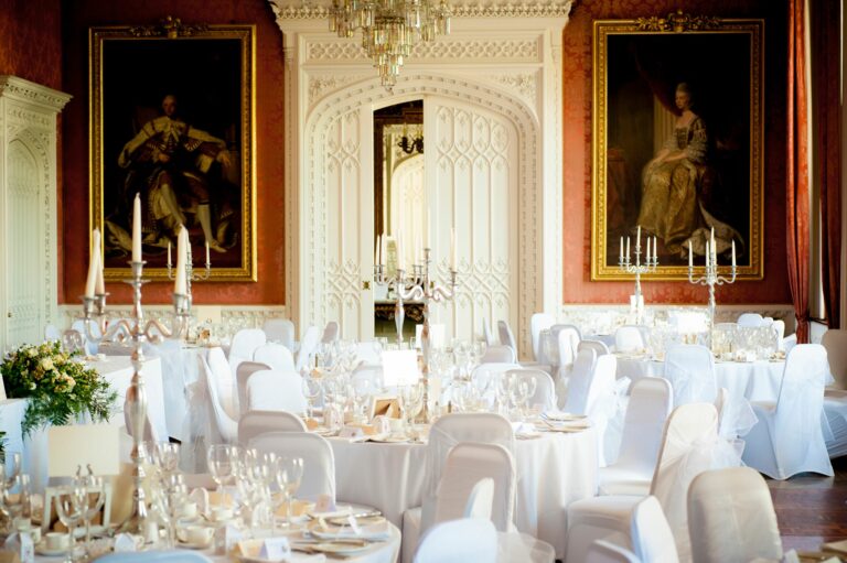 The Waldegrave Suite set with white linen and candelabra beneath its portraits, Strawberry Hill House