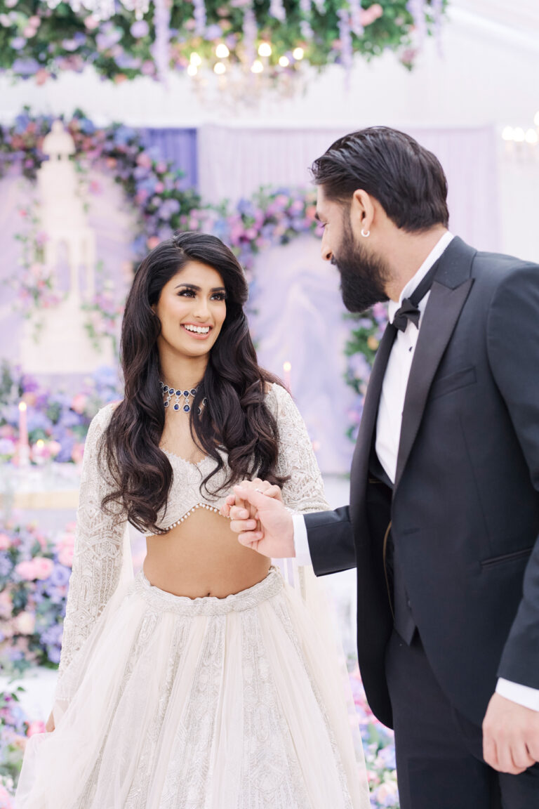 A bride and groom at a flower-filled reception, Stuart Wood Photography